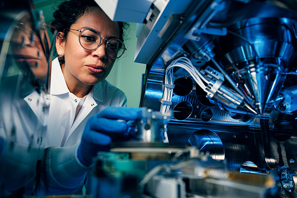 A researcher loading a sample into a vacuum characterization instrument at the Birck Nanotechnology Center.